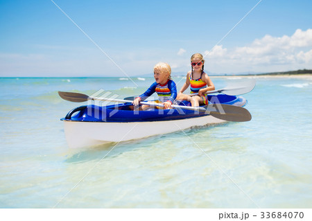 Kids kayaking in ocean. Children in kayak in sea Kids kayaking in ocean. Children in kayak in sea 33684070