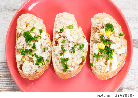 Slice of baguette with fish paste on glass plate 33688987