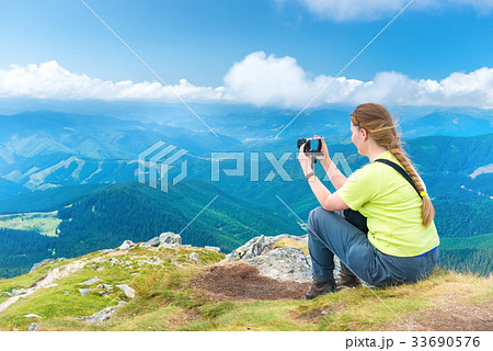 Young woman taking photo 33690576