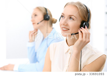 Call center. Focus on beautiful blonde woman in Call center. Focus on beautiful blonde woman in 33691093