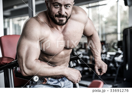 Handsome athletic man on diet training muscles Handsome athletic man on diet training muscles 33691276