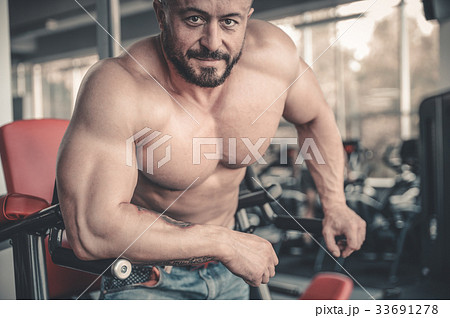 Handsome athletic man on diet training muscles Handsome athletic man on diet training muscles 33691278