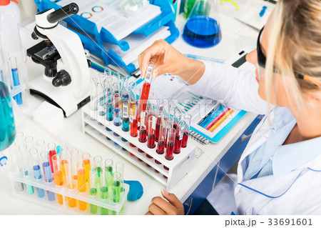 Woman scientist working with test tubes in the lab Woman scientist working with test tubes in the lab 33691601