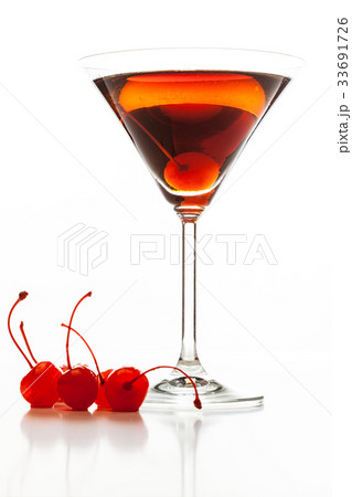 Manhattan cocktail garnished with a cherry Manhattan cocktail garnished with a cherry 33691726