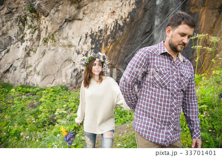 Hipster with a beard leads his bride in nature 33701401