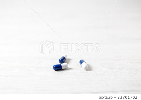 Three blue medicine capsules Three blue medicine capsules 33701702