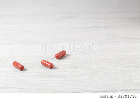 Three brown medicine capsules 33701716