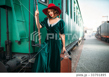 Woman in red hat against old railway wagon Woman in red hat against old railway wagon 33701895