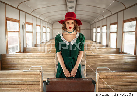 Woman with suitcase in retro train, old wagon 33701908