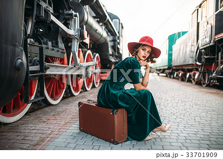 Woman in red hat against vintage steam train 33701909