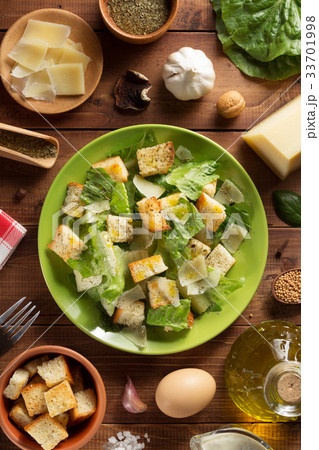 caesar salad in plate at wood 33701998