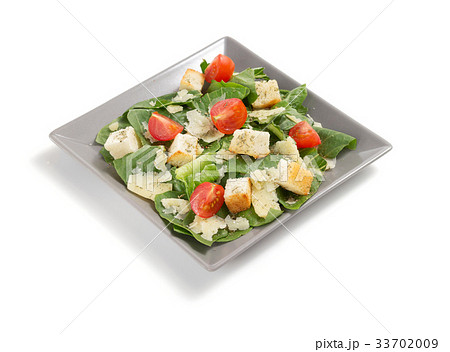 caesar salad in plate on white background caesar salad in plate on white background 33702009