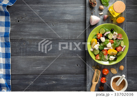 fresh greek salad in plate and ingredients 33702036
