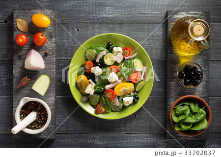 fresh greek salad in plate and ingredients 33702037