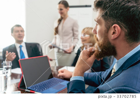 Business consultant listening to the manager of a 33702785