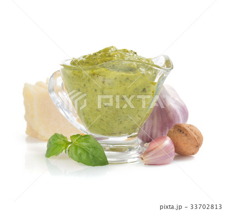 pesto sauce in gravy boat on white 33702813
