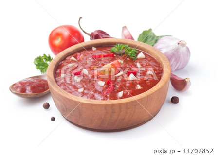 tomato sauce in gravy boat on white 33702852