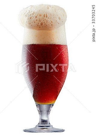 Mug of frosty dark red beer with foam 33703245