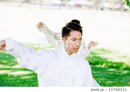 Handsome man practicing thai chi Handsome man practicing thai chi 33708331