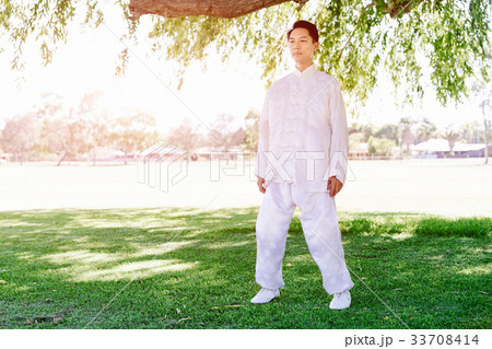 Handsome man practicing thai chi Handsome man practicing thai chi 33708414