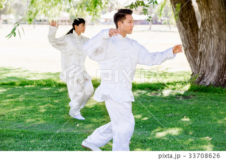 People practicing thai chi in park 33708626