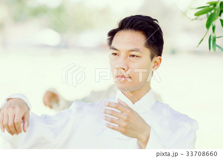 Handsome man practicing thai chi Handsome man practicing thai chi 33708660