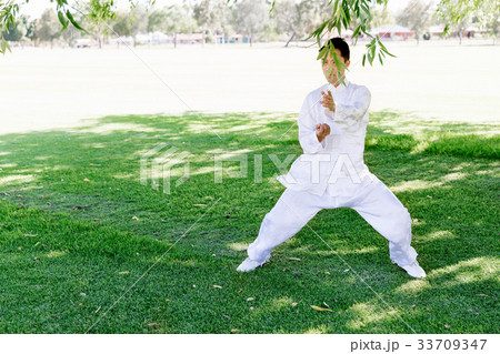 Handsome man practicing thai chi Handsome man practicing thai chi 33709347