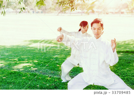 People practicing thai chi in park 33709485