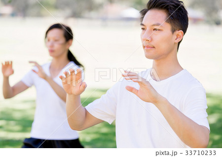 People practicing thai chi in park 33710233