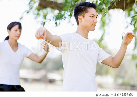 People practicing thai chi in park 33710436
