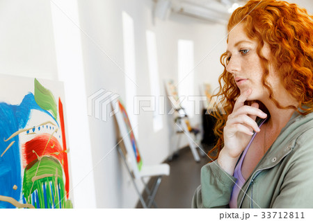 Young caucasian woman in art gallery front of paintings 33712811