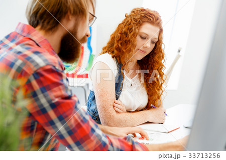 Co-workers working together 33713256