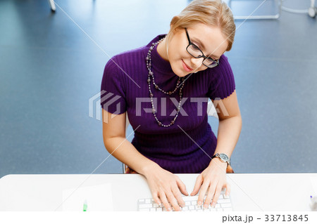 Business woman in office holding mobile phone 33713845