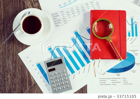 Financial charts and graphs on the table 33715105