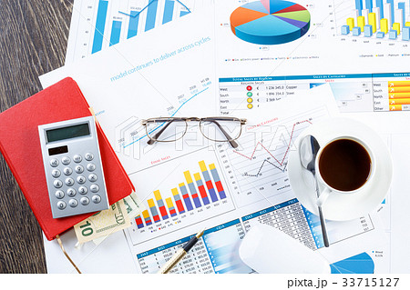 Financial charts and graphs on the table 33715127