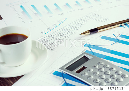 Financial charts and graphs on the table 33715134
