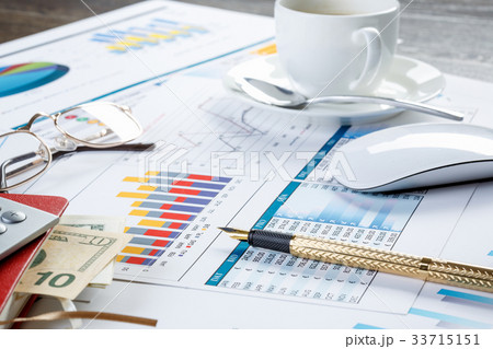 Financial charts and graphs on the table 33715151