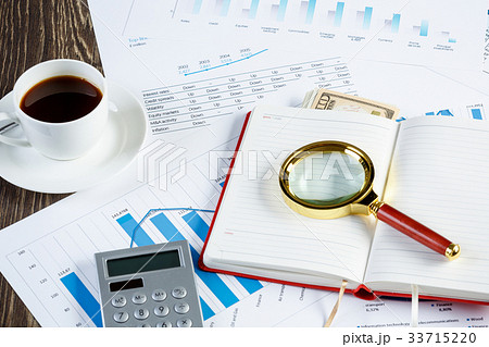 Financial charts and graphs on the table 33715220