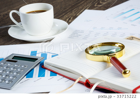 Financial charts and graphs on the table 33715222