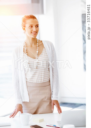 Attractive office worker standing 33716481
