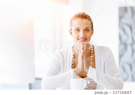 Attractive office worker sitting at desk Attractive office worker sitting at desk 33716687