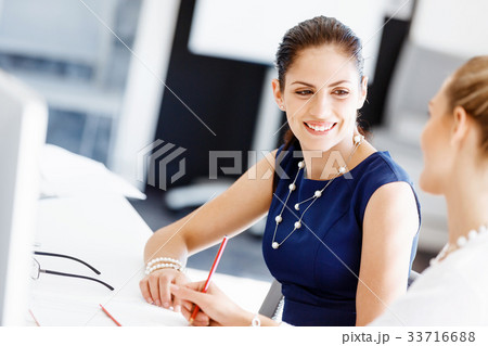 Two female colleagues in office Two female colleagues in office 33716688