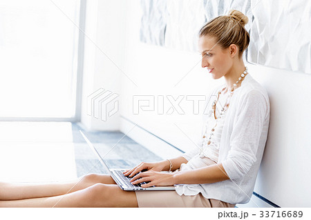 Attractive office worker sitting on floor Attractive office worker sitting on floor 33716689