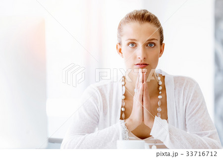 Attractive office worker sitting at desk 33716712