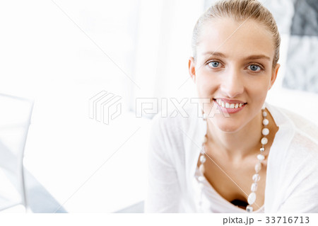 Attractive office worker sitting at desk 33716713