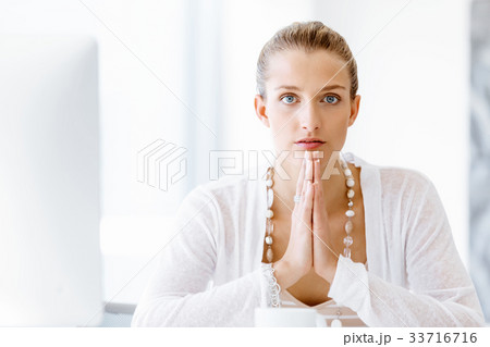Attractive office worker sitting at desk Attractive office worker sitting at desk 33716716