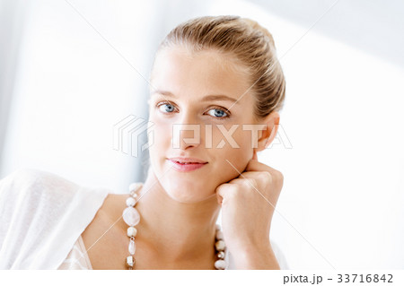 Attractive office worker sitting at desk 33716842