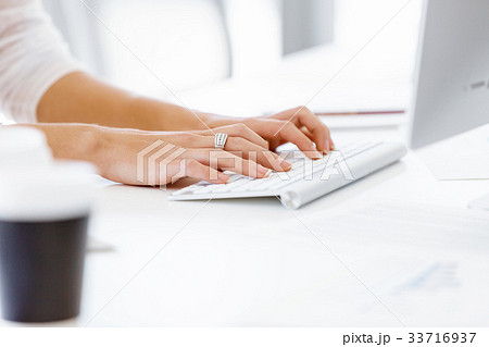 Female hands typing on the keyboard Female hands typing on the keyboard 33716937