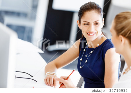 Two female colleagues in office 33716953