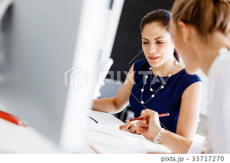 Two female colleagues in office 33717270